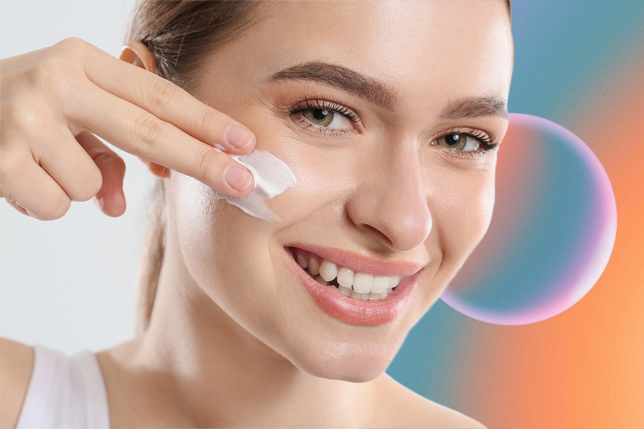 White clay mask benefits, a young woman applying a white clay mask