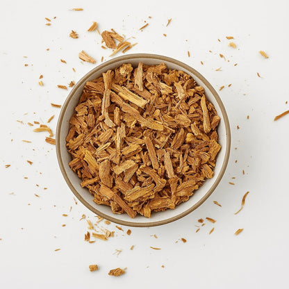 Top view of dried Borututu bark in a ceramic bowl on a light background – herbal root tea cut