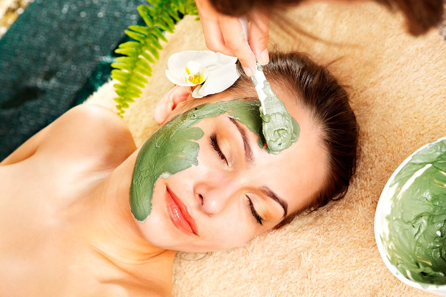 Facial treatment with green clay detox mask